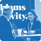 blue tinted image of two people talking