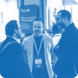 blue tinted image of 3 people talking